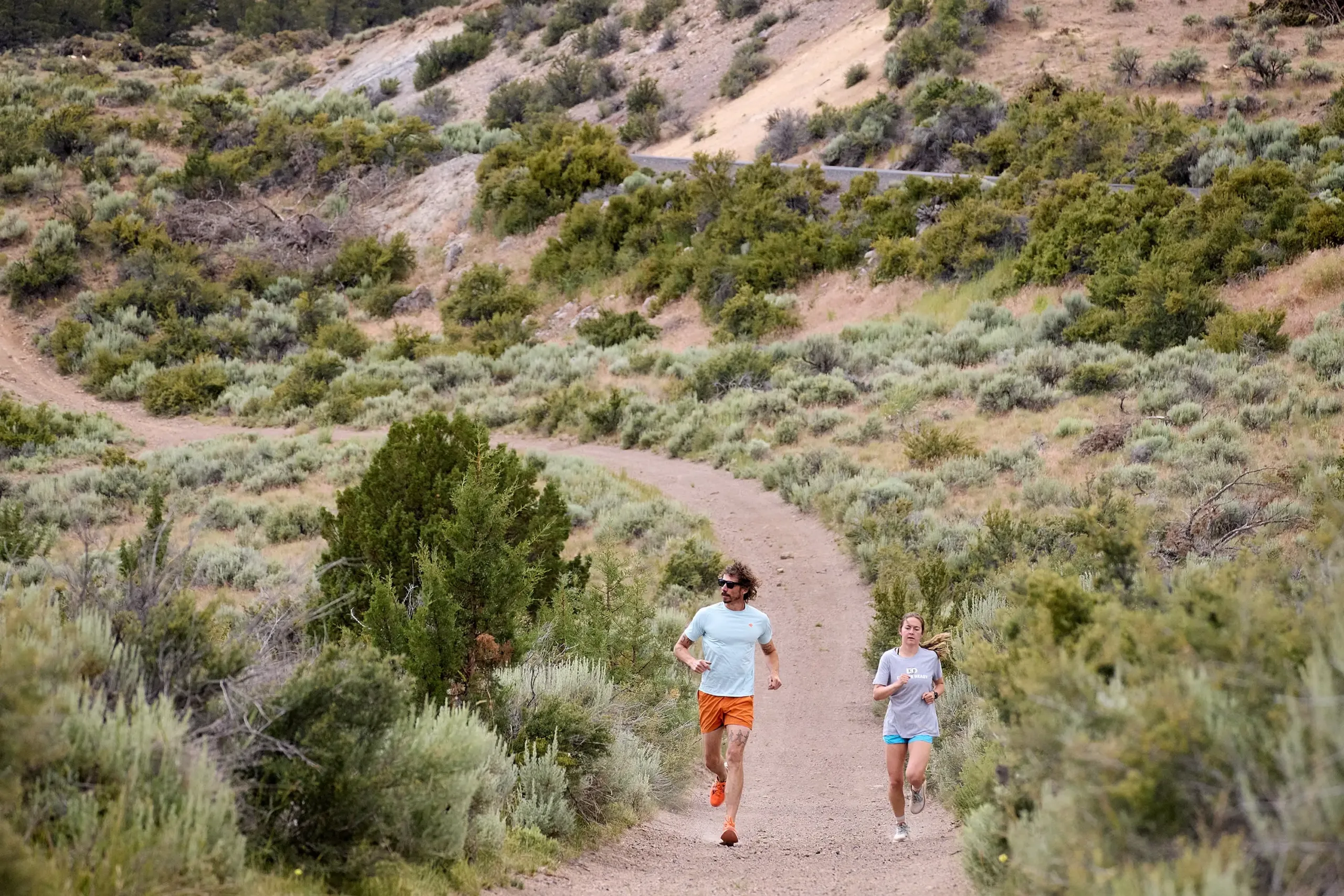 A couple running down a trail in Harney County.