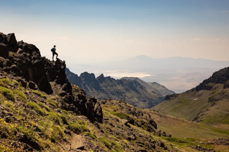 A hiker standing at the edge of a cropping of rocks